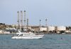 yacht-on-water-near-industrial-refinery-coastal-facility.jpg - RadarPress